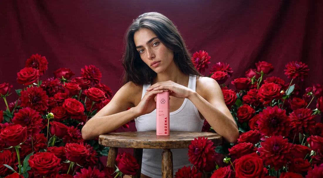 Rozena Maison Milky Oil Foaming Cleanser surrounded by deep red flowers